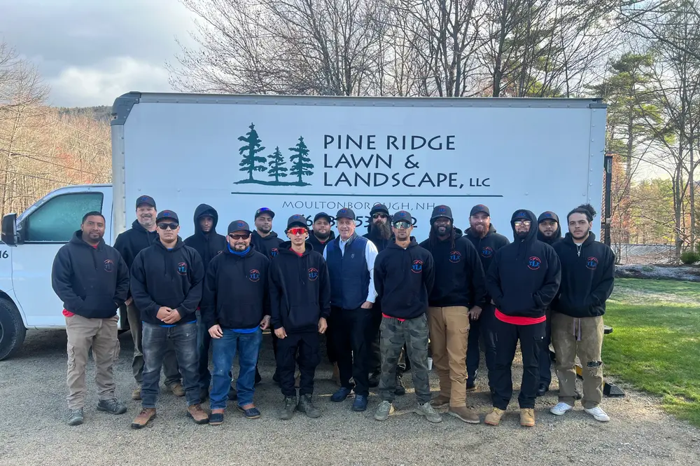 TLE Landscape and Design team standing in front of a company truck