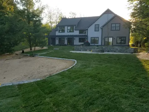 Completed landscape around a wooded Lakes Region home
