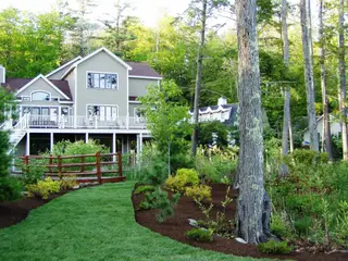 Established landscape with rustic fencing and wood deck access