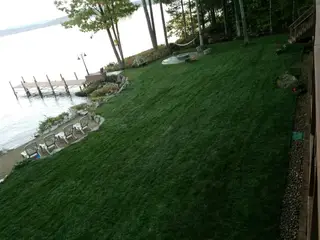 Lakeside Backyard And Beach With Lounge Chairs