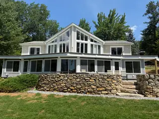 Lakeside home rear elevation with vaulted window gable