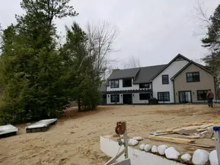 Modern farmhouse landscape installation with stone edging