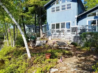 Multi-level contemporary home with landscaped gravel streambed pathway