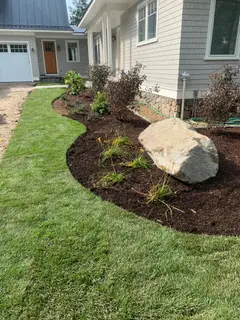 Overhead view of boulder bed beside home entrance