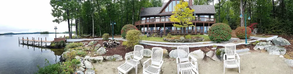 Guests enjoying a broad lakeside patio and deck
