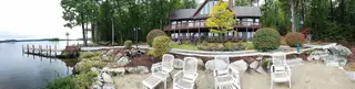 Panoramic Lakeside Patio With Guests On Deck