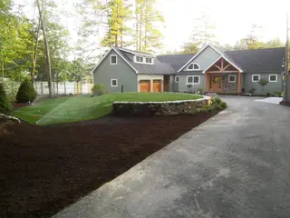 Waterfront boathouse with stone retaining wall and beach access