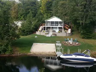 Waterfront landscape with boathouse and waterside gathering area