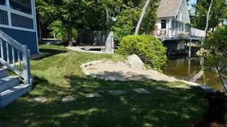 Waterfront shoreline with stone edging and gravel beach access