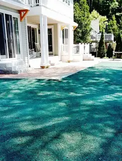Hydroseeded yard with modern home and paver patio