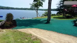 Waterfront hydroseeding with dock and mountain views