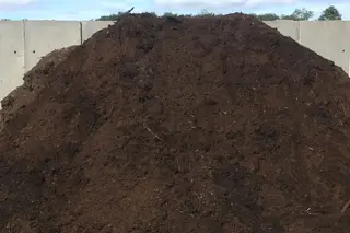 Large pile of dark screened topsoil