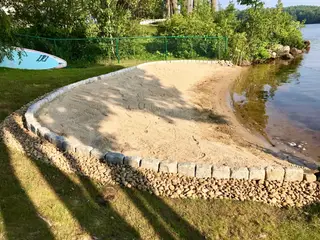 Freshly graded soil along lakeshore riprap