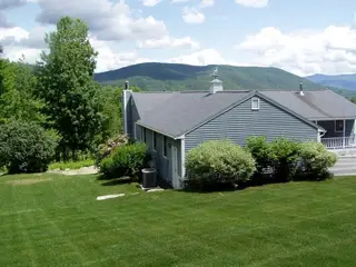 Mountain-view home with manicured lawn