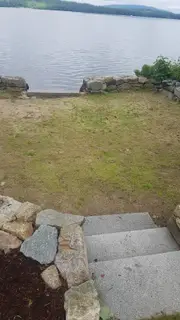 Stone steps between lawn and sandy beach