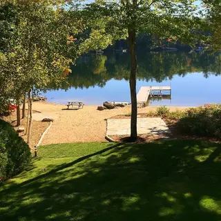 Striped lawn leading to lakeside beach