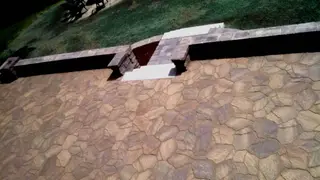Aerial view of paver walkway meeting stone patio