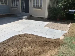 Bluestone patio with granite steps near flower boxes