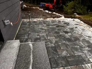 Bluestone paver patio with excavator in background