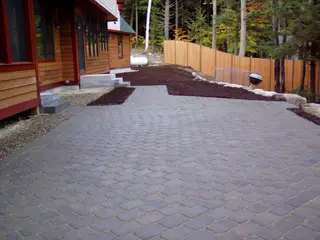 Cobblestone paver driveway through fall woods