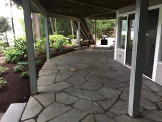Covered flagstone patio under raised deck
