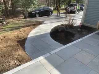 Curved bluestone walkway around planting bed