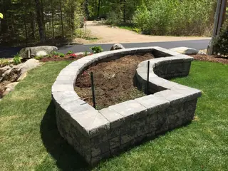 Curved stone block planter with netting