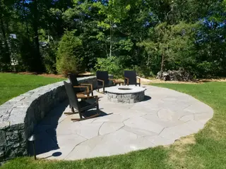Curved stone patio with fire pit seating