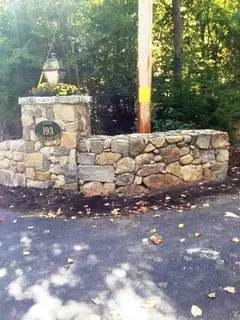 Fieldstone entrance wall with address plaque