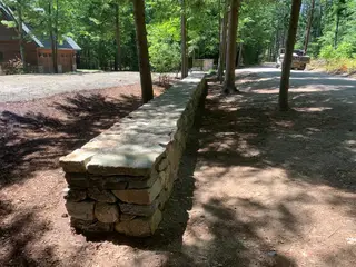 Fieldstone wall corner pillar near driveway