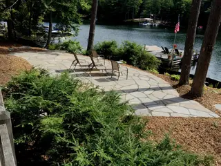 Flagstone lakeside patio with lounge chairs