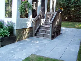 Flagstone patio with wooden deck stairs
