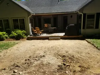 Graded dirt area for new patio behind ranch home
