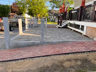 Granite bollards along paver patio at cafe