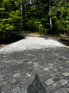 Granite cobblestone pavement along wooded path