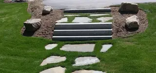 Granite steps and stepping-stone path through lawn