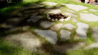 Grass-jointed flagstone patio with small fire pit