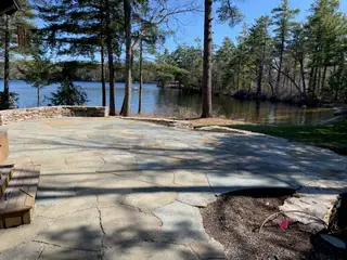 Lakeside flagstone patio with stone wall