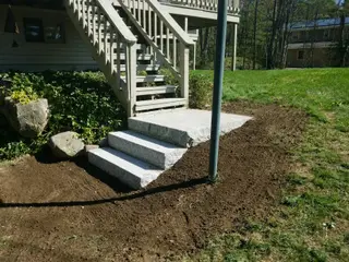 New granite steps beside deck with boulder accents