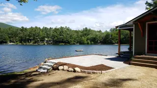 Paver patio and granite steps down to lake