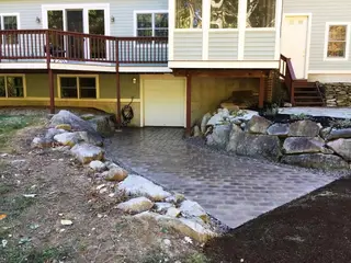 Paver walkway between boulder retaining walls