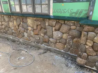 River rock veneer wall beside entry door