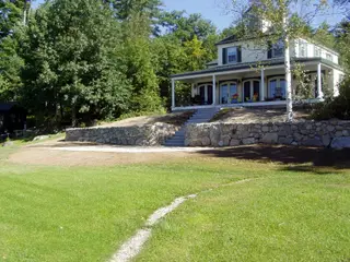 River-stone retaining wall with staircase to porch