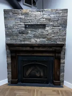 Stacked stone fireplace surround with TV mount