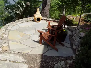 Stone patio with chiminea overlooking lake