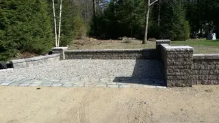 Stone retaining wall with pillars