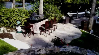Waterfront stone patio bar with boat dock