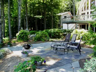 Wooded flagstone patio with fire bowl seating
