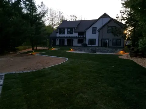 Low-voltage lighting along a backyard patio at twilight