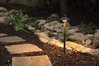Mushroom path lights along gravel garden path